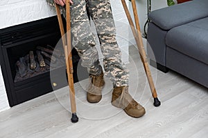 soldier in khaki military uniform on crutches