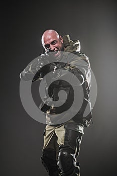 Soldier man hold Machine gun on a dark background