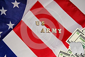 The soldier military tokens on dollar bills on the USA flag background with words US Army. Soldiers of fortune military power