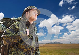 Soldier in military uniform with backpack hiking