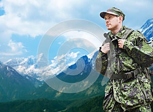 Soldier in military uniform with backpack hiking