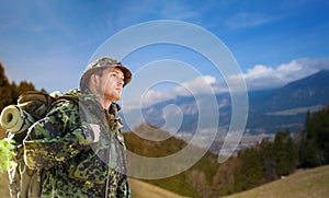 Soldier in military uniform with backpack hiking