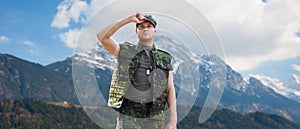 Soldier in military uniform over mountains