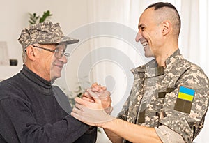 Soldier in military uniform reunited with his family and Ukrainian flag