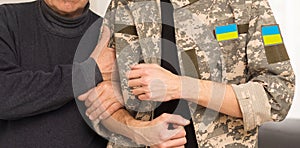 Soldier in military uniform reunited with his family and Ukrainian flag