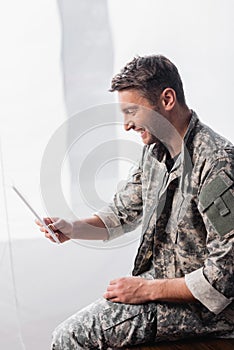 Soldier in military uniform using digital