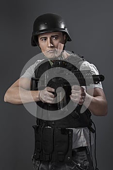 Soldier, paintball sport player wearing protective helmet aiming