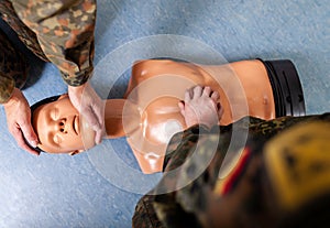 Soldier practices a medical training on a puppet