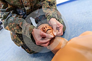 Soldier practices a medical training on a puppet