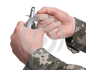 Soldier pulling safety pin out of hand grenade on white background, closeup. Military service