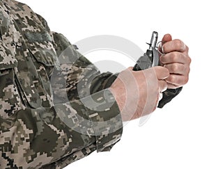 Soldier pulling safety pin out of hand grenade on white background, closeup. Military service