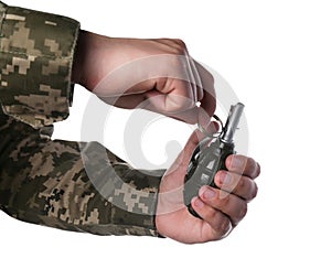 Soldier pulling safety pin out of hand grenade on white background, closeup