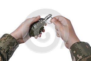 Soldier pulling safety pin out of hand grenade on white background, closeup