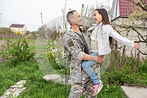 Soldier reunited with his daughter on a sunny day.