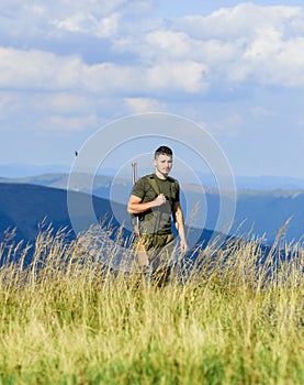 Soldier with rifle. Man with weapon military clothes in field nature background. Army forces. State border guard service