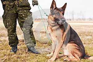 Soldier& x27;s best friend. A soldier standing with his dog.