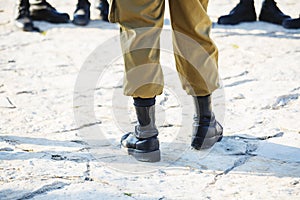 The soldier`s footwear of the Israeli army which is put on legs in clear sunny day