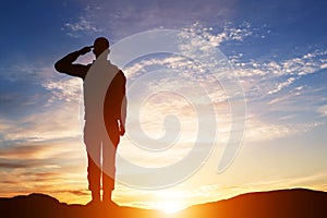 Soldier salute. Silhouette on sunset sky. Army, military.