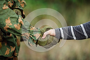 Soldier shaking hands with civil man