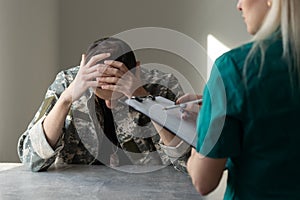 Soldier sitting on the sofa during psychological therapy