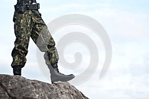 Soldier stand on the rock in nature