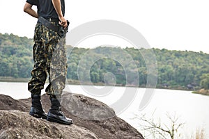 Soldier stand on the rock in nature