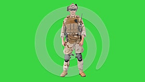 Soldier standing, listening and nodding on a Green Screen, Chroma Key.