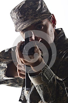 Soldier taking aim with assault rifle, vertical