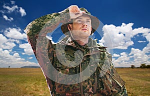 Soldier or traveler in military uniform over sky