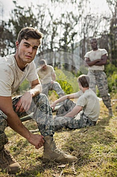 Soldier tying his shoe laces in boot camp