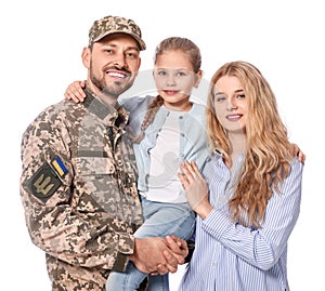 Soldier in Ukrainian military uniform reunited with his family on white background