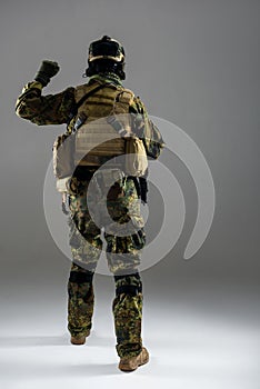 Soldier in uniform rising hand up