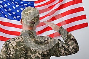 Soldier in uniform and United states of America flag on white background, back view