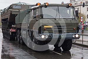 Soldiers of Czech Army are riding military truck with floating transporter