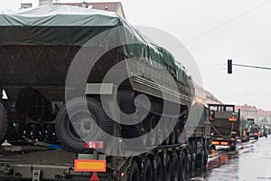 Soldiers of Czech Army are riding military truck with floating transporter