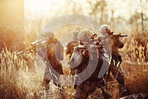 Soldiers with guns on the field