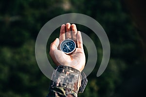 Soldiers holding compass for determines the location