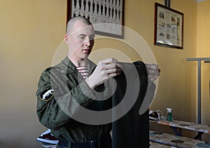 Soldiers of internal troops stroking form in the utility room of the barracks.