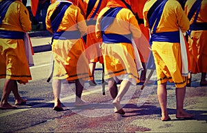 Soldiers with orange clothes march through the city during a fes