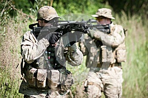 Soldiers on patrol aiming on enemy photo