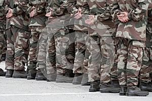 Soldiers in a relaxed position during the ceremony. Military camouflage outfit