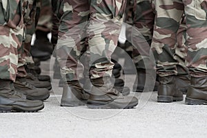 Soldiers in a relaxed position during the ceremony. Military camouflage outfit