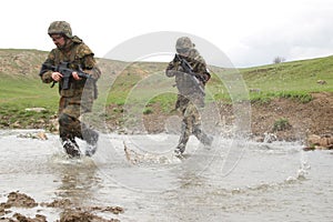 Soldiers running across the water