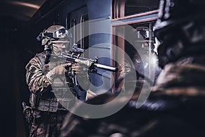 Soldiers of a special anti-terrorist unit storm a railway carriage in the subway. Special operation concept