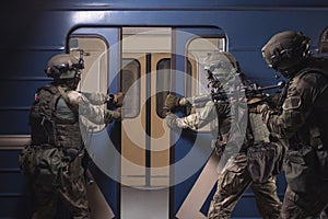 Soldiers of a special anti-terrorist unit storm a railway carriage in the subway. Special operation concept