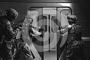 Soldiers of a special anti-terrorist unit storm a railway carriage in the subway. Special operation concept