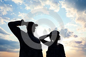 Soldiers in uniform saluting. Military service photo