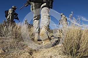 Soldiers Walking In Desert