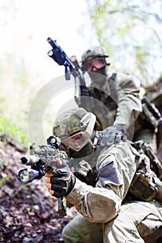 Soldiers with weapons on exercises photo
