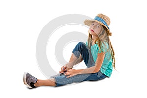 Solemn thoughtful little girl sitting on ground